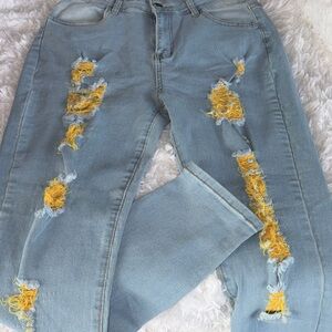 Stylish Distressed Light Blue Jeans with Yellow Accents